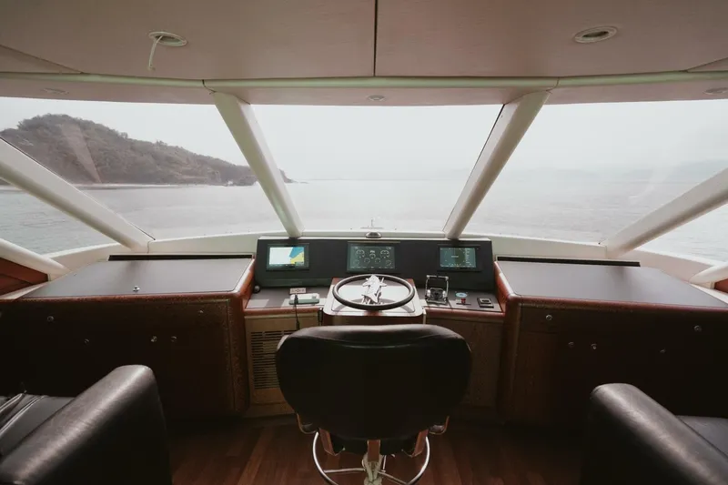 Aussie Rules Yacht Photos Pics Interior view of 1996 Oceanfast 87 Enclosed Bridge yacht helm with panoramic windows.