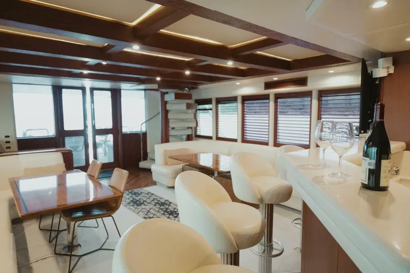 Aussie Rules Yacht Photos Pics Luxurious interior of 1996 Oceanfast 87 Enclosed Bridge yacht with elegant seating and dining area.