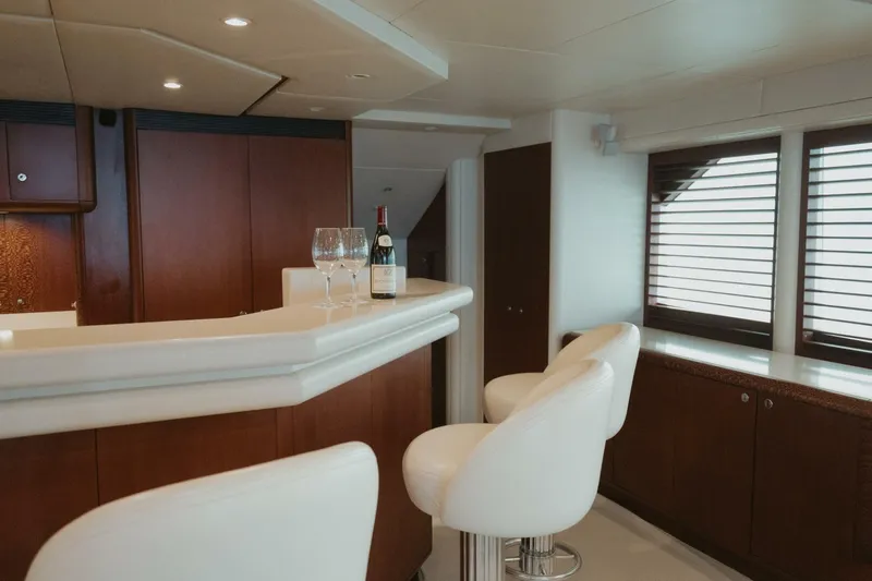 Aussie Rules Yacht Photos Pics Luxurious yacht interior with bar, wine, and elegant seating on Oceanfast 87 Enclosed Bridge, 1996.