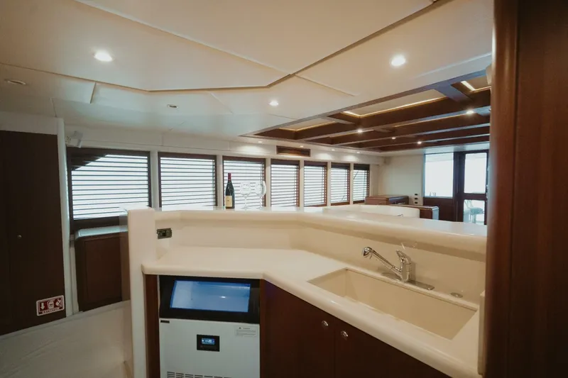 Aussie Rules Yacht Photos Pics Luxurious interior of 1996 Oceanfast 87 Enclosed Bridge yacht with modern kitchen design.