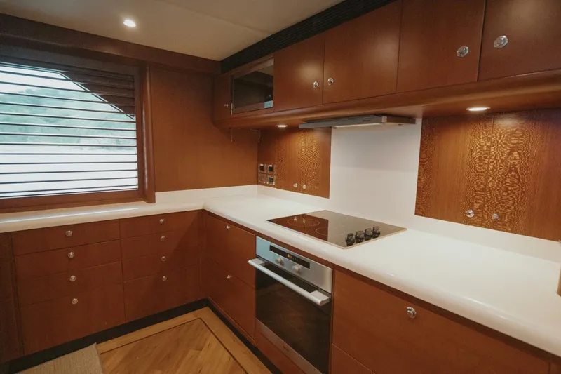 Aussie Rules Yacht Photos Pics Luxurious wooden kitchen interior on 1996 Oceanfast 87 Enclosed Bridge yacht.