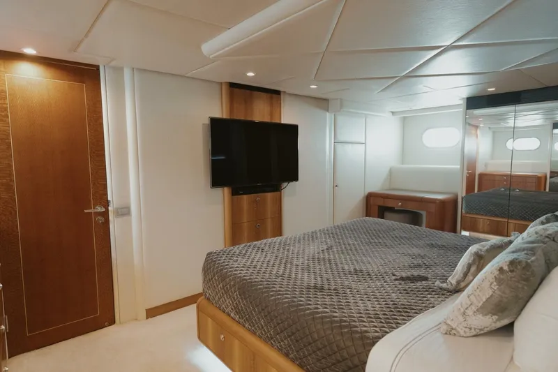Aussie Rules Yacht Photos Pics Luxurious bedroom interior of 1996 Oceanfast 87 Enclosed Bridge yacht with modern amenities.
