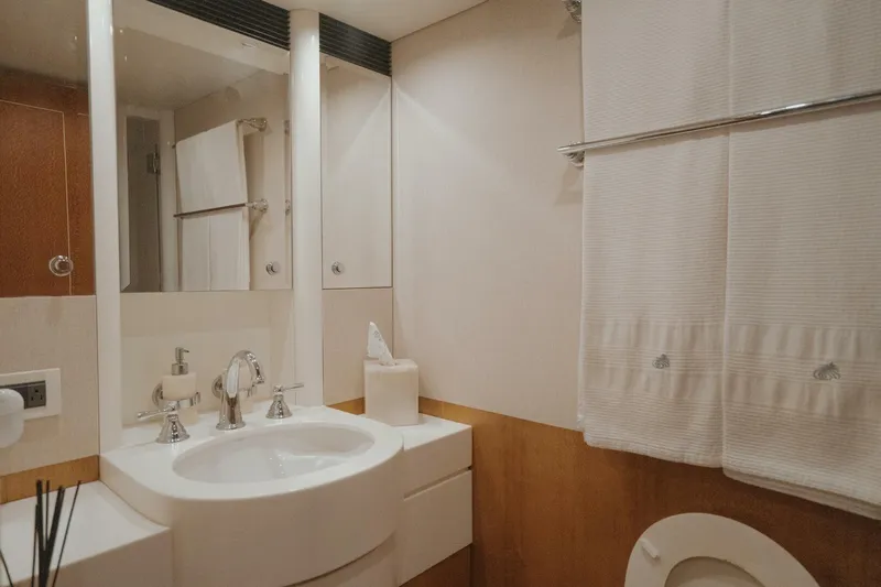 Aussie Rules Yacht Photos Pics Luxurious bathroom in 1996 Oceanfast 87 Enclosed Bridge yacht, featuring elegant fixtures and decor.