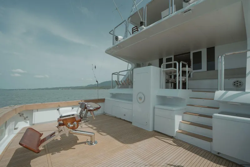 Aussie Rules Yacht Photos Pics Luxurious 1996 Oceanfast 87 Enclosed Bridge yacht deck with fishing chair and ocean view.