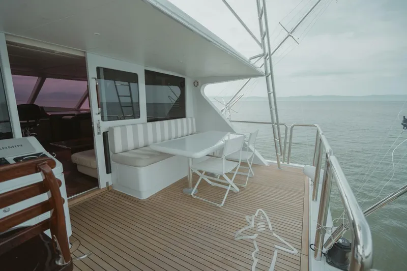 Aussie Rules Yacht Photos Pics Luxurious 1996 Oceanfast 87 Enclosed Bridge yacht with elegant outdoor seating and ocean view.