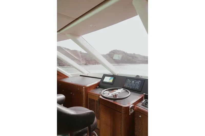Aussie Rules Yacht Photos Pics Interior view of 1996 Oceanfast 87 Enclosed Bridge yacht helm with navigation controls.
