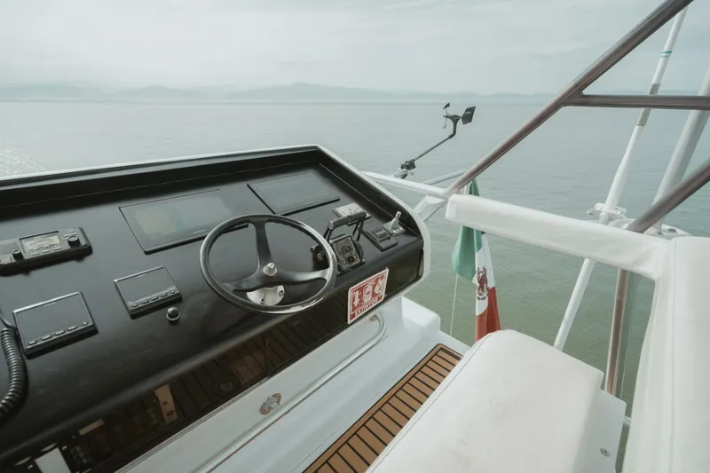 Aussie Rules Yacht Photos Pics Cockpit of 1996 Oceanfast 87 Enclosed Bridge yacht with steering wheel and controls.