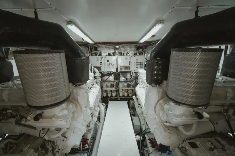 Aussie Rules Yacht Photos Pics Engine room of 1996 Oceanfast 87 Enclosed Bridge yacht, featuring dual engines and control panels.