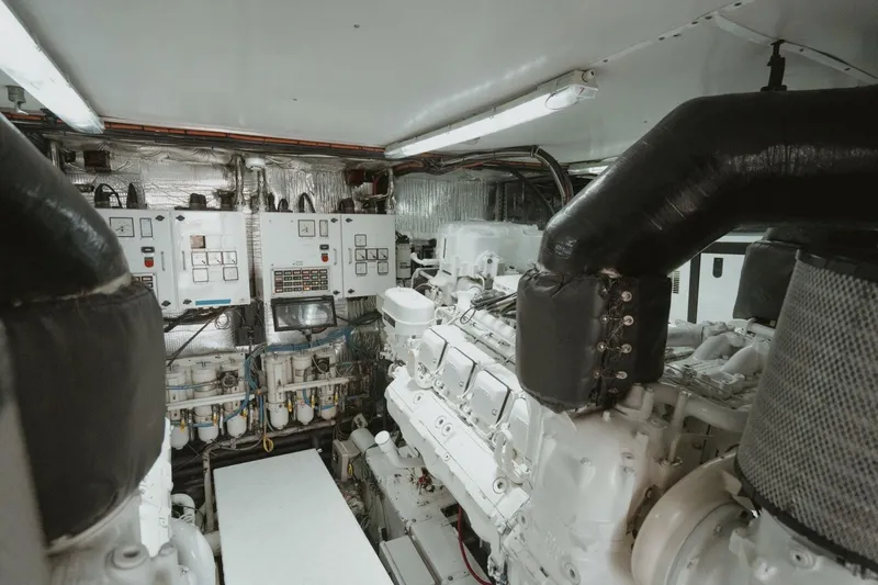 Aussie Rules Yacht Photos Pics Engine room of 1996 Oceanfast 87 Enclosed Bridge yacht, featuring complex machinery and control panels.