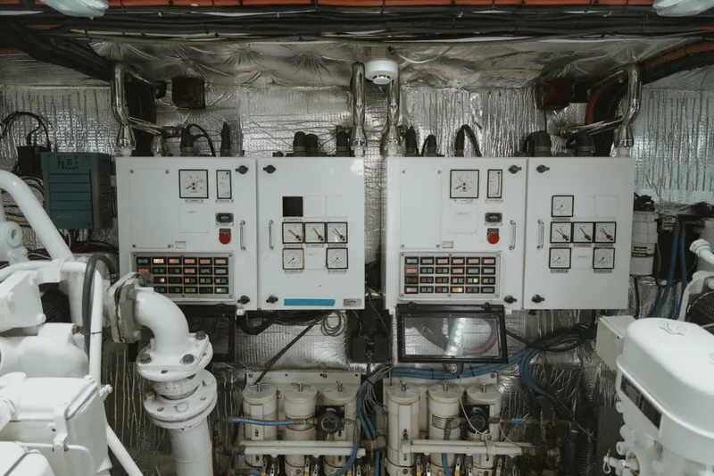 Aussie Rules Yacht Photos Pics Engine room of 1996 Oceanfast 87 Enclosed Bridge yacht with control panels and machinery.