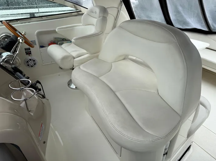  Yacht Photos Pics 2003 Sea Ray 380 Sundancer cockpit with white leather seating and steering wheel.