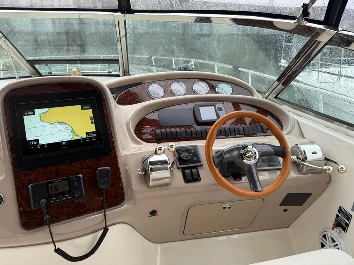  Yacht Photos Pics 2003 Sea Ray 380 Sundancer helm with navigation system and wooden steering wheel.
