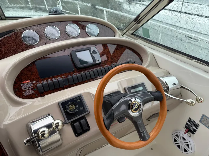  Yacht Photos Pics 2003 Sea Ray 380 Sundancer helm with wood steering wheel and modern controls.