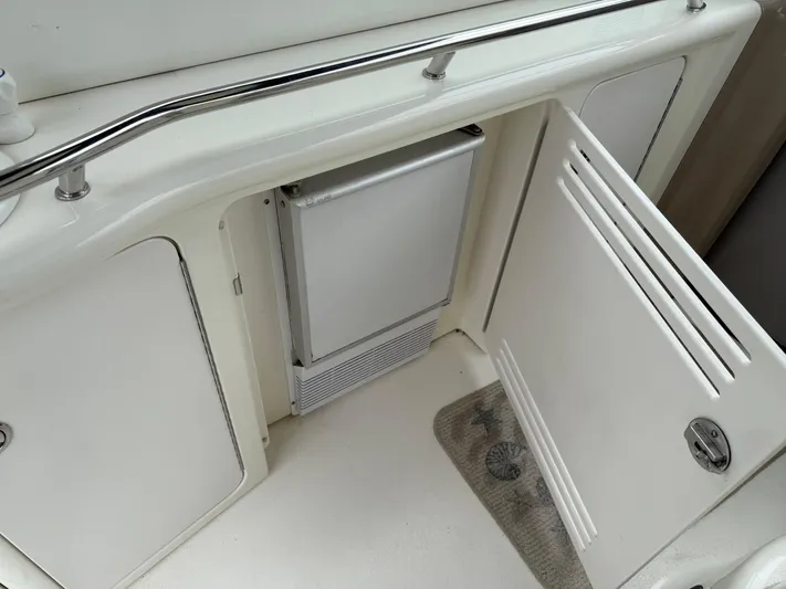  Yacht Photos Pics 2003 Sea Ray 380 Sundancer interior with open storage compartment and mini fridge.