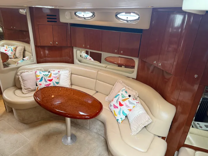  Yacht Photos Pics Luxurious interior of 2003 Sea Ray 380 Sundancer yacht with elegant seating and wooden table.