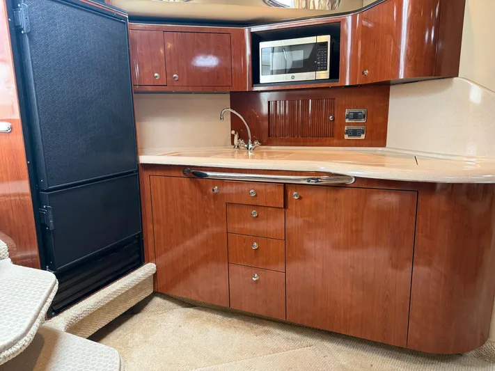  Yacht Photos Pics Luxurious 2003 Sea Ray 380 Sundancer yacht kitchen with wood cabinetry and modern appliances.