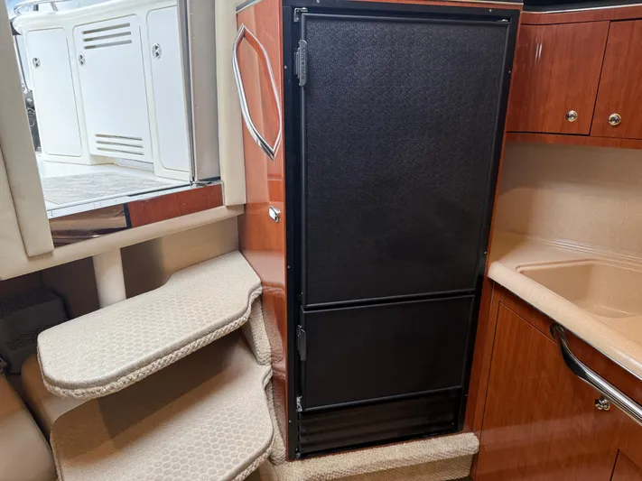  Yacht Photos Pics Interior of 2003 Sea Ray 380 Sundancer with stairs and black refrigerator.