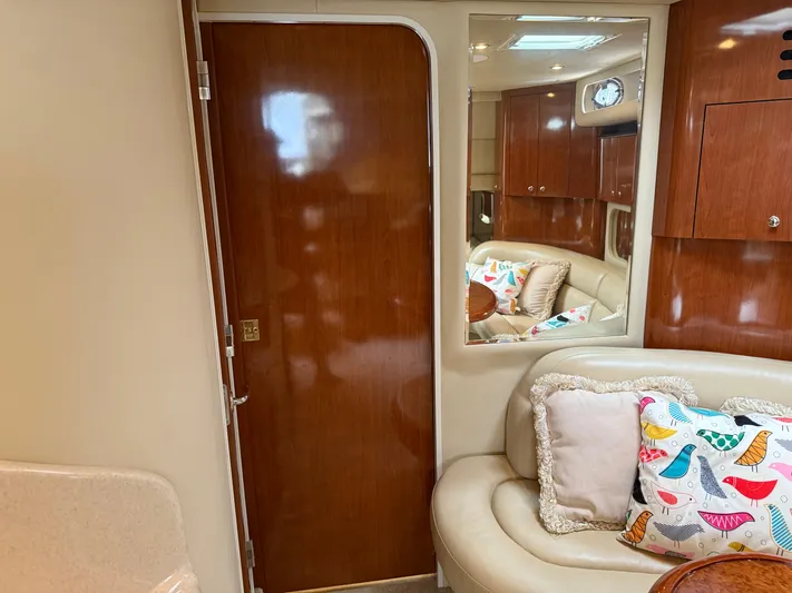  Yacht Photos Pics Interior of 2003 Sea Ray 380 Sundancer with wooden door, plush seating, and colorful pillows.