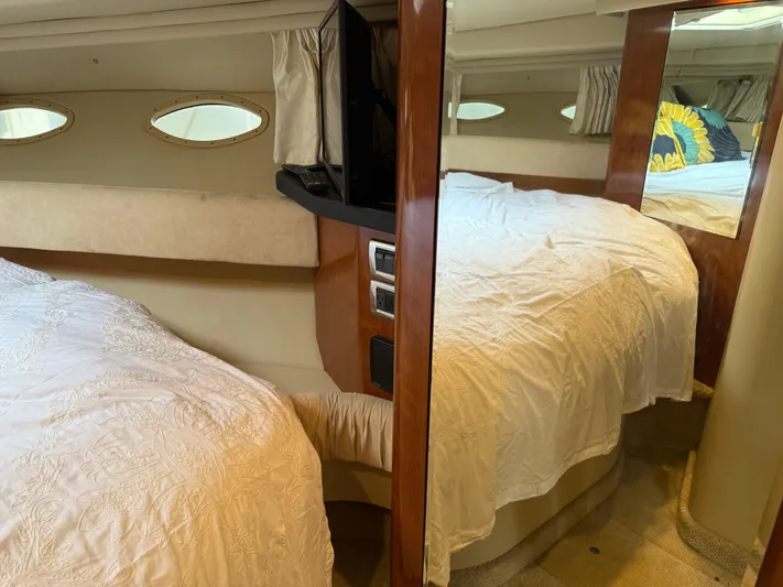  Yacht Photos Pics Interior cabin of 2003 Sea Ray 380 Sundancer with cozy bedding and porthole windows.