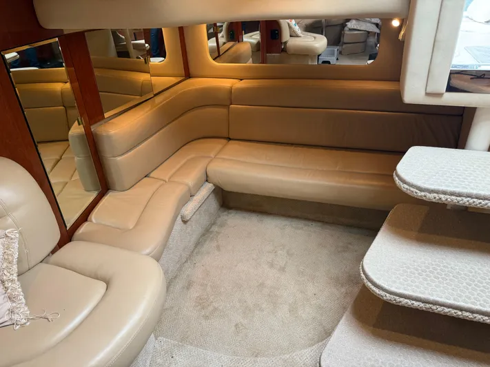  Yacht Photos Pics Luxurious interior of 2003 Sea Ray 380 Sundancer with beige leather seating and carpeted floor.