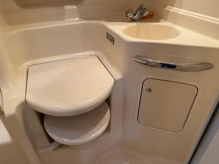  Yacht Photos Pics 2003 Sea Ray 380 Sundancer bathroom with toilet, sink, and storage compartment.