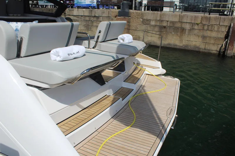 Mby Motor Boat Of The Year 2025 Yacht Photos Pics 2025 Fairline Targa 40 yacht with teak deck and sun loungers at dock.