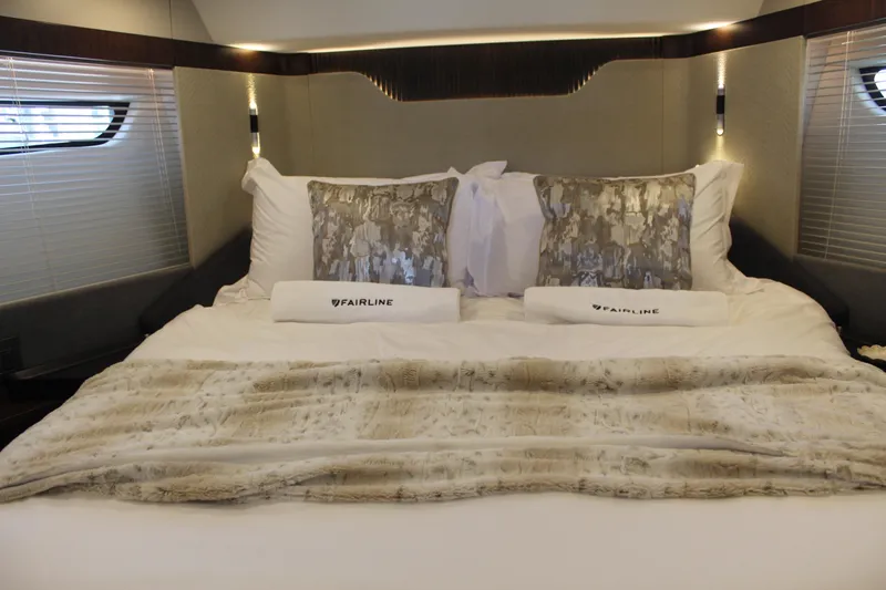 Mby Motor Boat Of The Year 2025 Yacht Photos Pics Luxurious bedroom interior of 2025 Fairline Targa 40 yacht with elegant bedding.