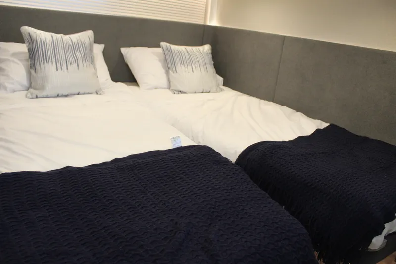 Mby Motor Boat Of The Year 2025 Yacht Photos Pics Interior cabin of 2025 Fairline Targa 40 yacht with twin beds and navy blankets.