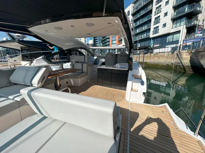 Mby Motor Boat Of The Year 2025 Yacht Photos Pics 2025 Fairline Targa 40 yacht with modern interior, docked in urban marina.