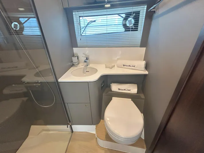 Mby Motor Boat Of The Year 2025 Yacht Photos Pics Modern bathroom in 2025 Fairline Targa 40 yacht with shower, sink, and toilet.