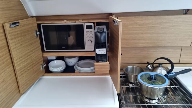 Yula Yacht Photos Pics 2024 X-Yachts Xc 47 yacht kitchen with microwave, coffee maker, and cookware.