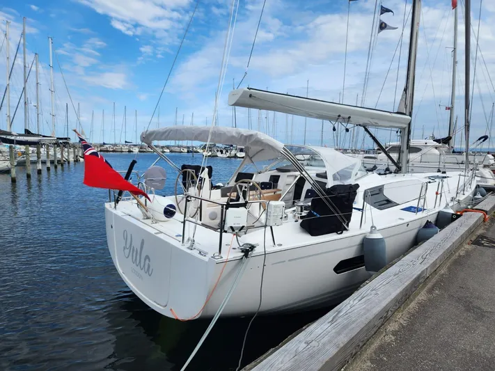 Yula Yacht Photos Pics 2024 X-Yachts Xc 47 sailboat docked at marina under blue sky.