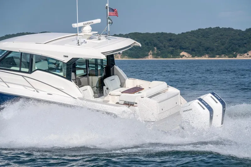  Yacht Photos Pics 2025 Tiara Yachts 43 LE cruising on water, showcasing sleek design and powerful engines.