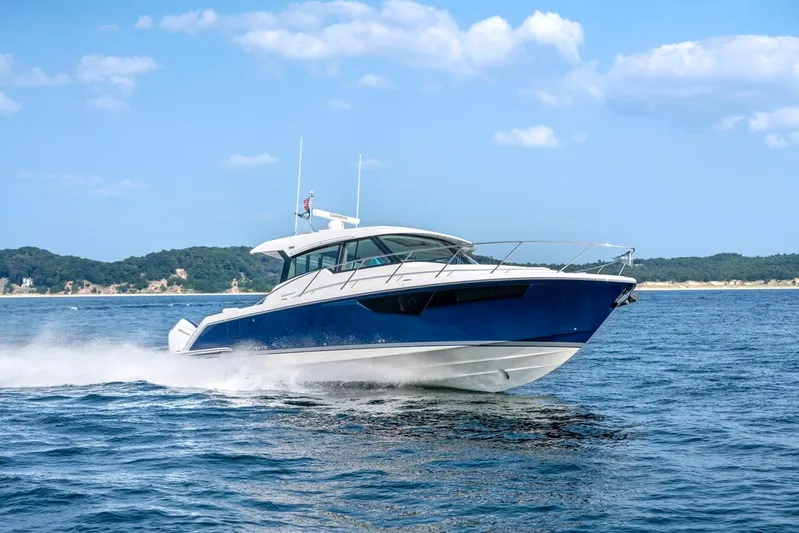  Yacht Photos Pics 2025 Tiara Yachts 43 LE cruising on open water under a clear blue sky.