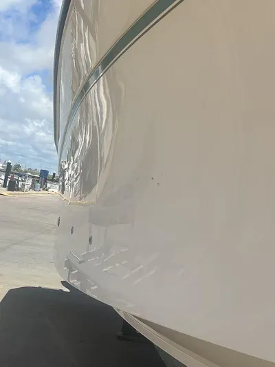  Yacht Photos Pics 2012 Grady-White 336 Canyon boat hull in a marina setting.