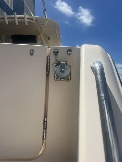  Yacht Photos Pics 2012 Grady-White 336 Canyon boat detail with latch and railing under blue sky.