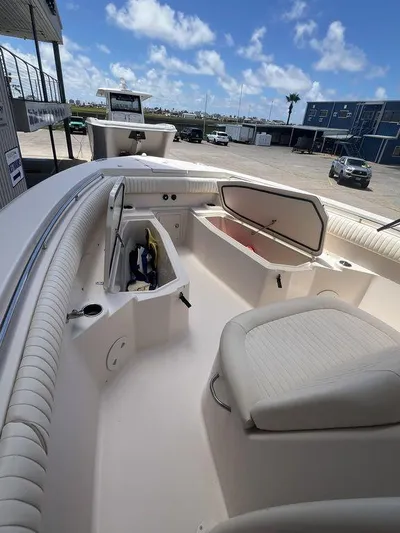  Yacht Photos Pics 2012 Grady-White 336 Canyon boat interior with open storage compartments, docked under a clear sky.