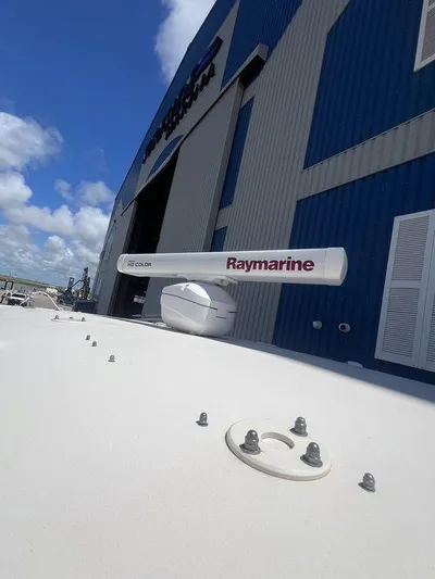  Yacht Photos Pics 2012 Grady-White 336 Canyon with Raymarine radar, docked near a blue building.