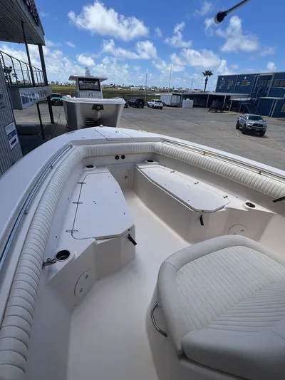  Yacht Photos Pics 2012 Grady-White 336 Canyon boat interior with seating, docked under blue sky.