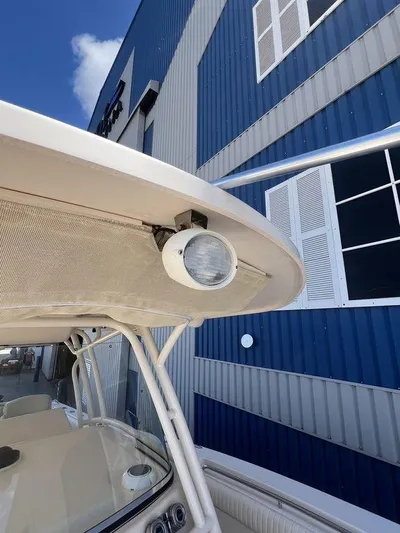  Yacht Photos Pics 2012 Grady-White 336 Canyon boat detail with spotlight, against blue building background.