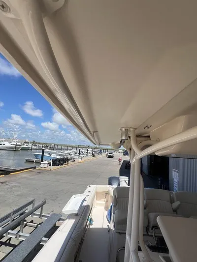  Yacht Photos Pics 2012 Grady-White 336 Canyon boat docked at marina under clear blue sky.