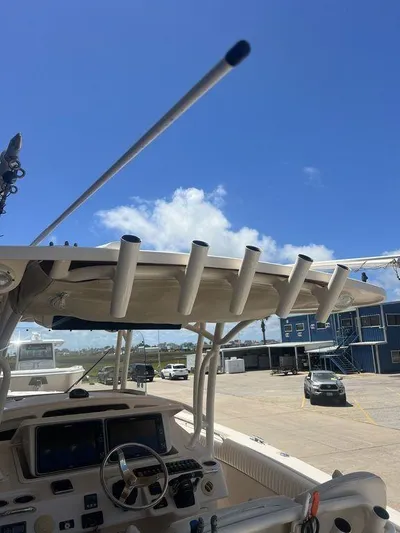  Yacht Photos Pics 2012 Grady-White 336 Canyon boat dashboard with rod holders under a clear blue sky.