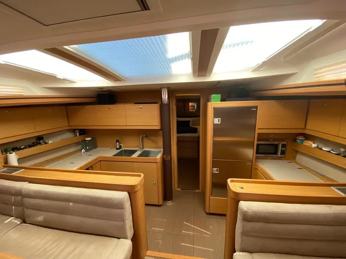  Yacht Photos Pics Luxurious interior of 2017 Dufour Exclusive 56 yacht with modern kitchen amenities.