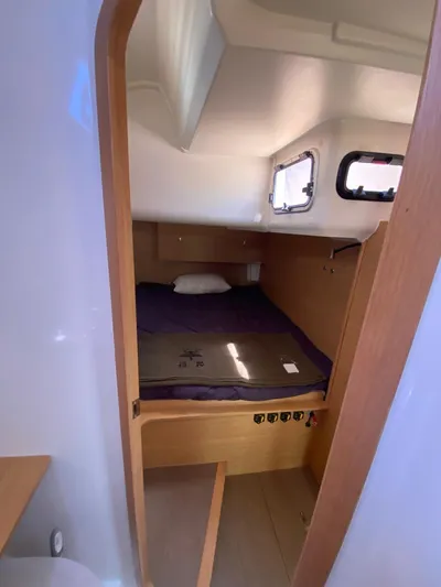  Yacht Photos Pics 2017 Dufour Exclusive 56 yacht cabin with bed, wooden interior, and windows.