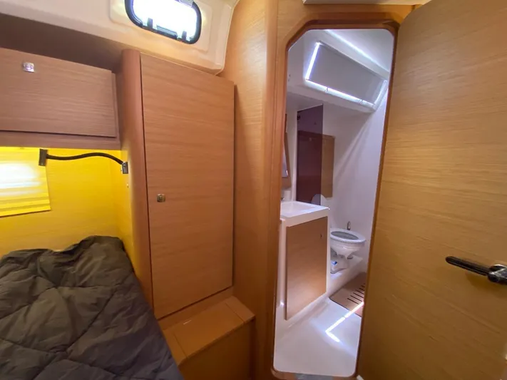  Yacht Photos Pics Cabin interior of 2017 Dufour Exclusive 56 yacht, featuring cozy bed and modern bathroom.