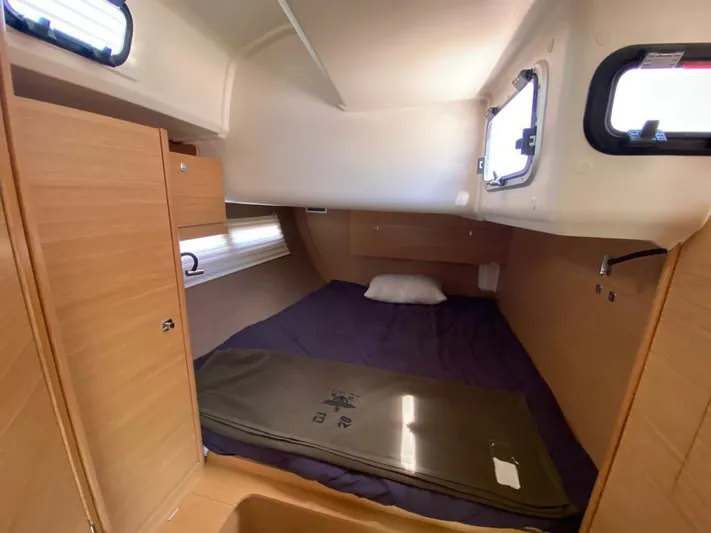  Yacht Photos Pics Cabin interior of 2017 Dufour Exclusive 56 yacht with bed and wooden finish.