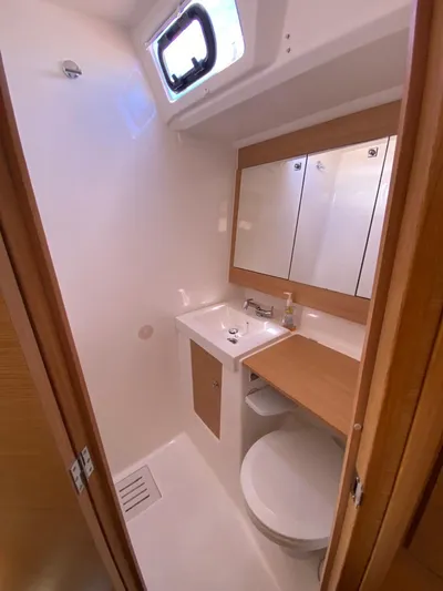  Yacht Photos Pics 2017 Dufour Exclusive 56 yacht bathroom with sink, mirror, and toilet.