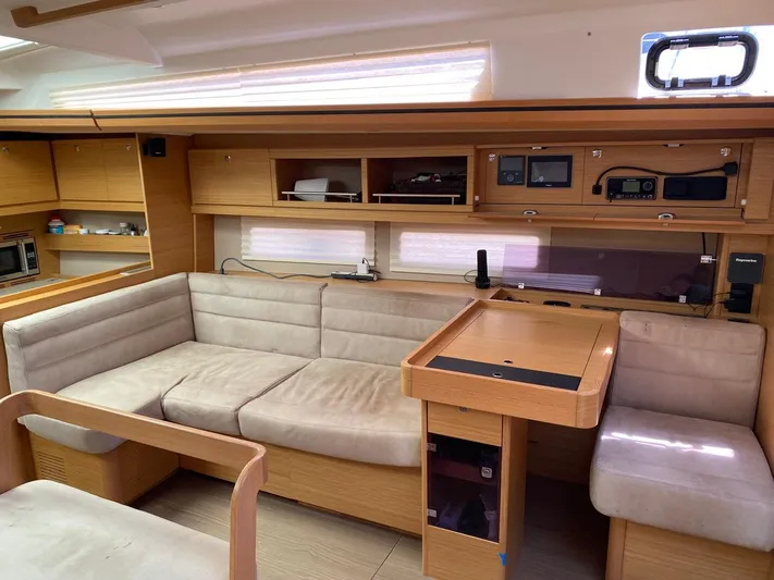  Yacht Photos Pics Interior of 2017 Dufour Exclusive 56 yacht with beige seating and wooden cabinetry.