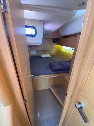  Yacht Photos Pics Interior cabin of 2017 Dufour Exclusive 56 yacht with cozy bed and wooden finish.
