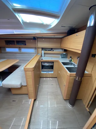  Yacht Photos Pics Interior of 2017 Dufour Exclusive 56 yacht with modern kitchen and seating area.